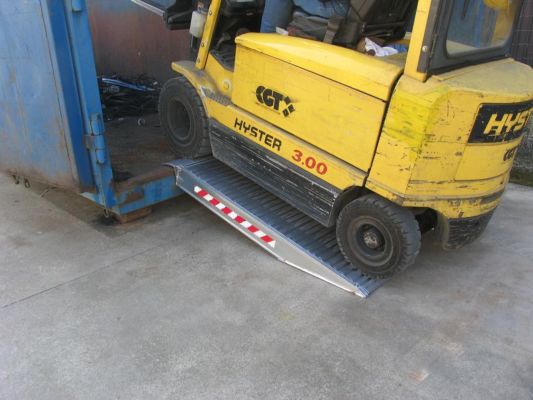 Forklift driving into a container on a Pair of aluminium container ramps